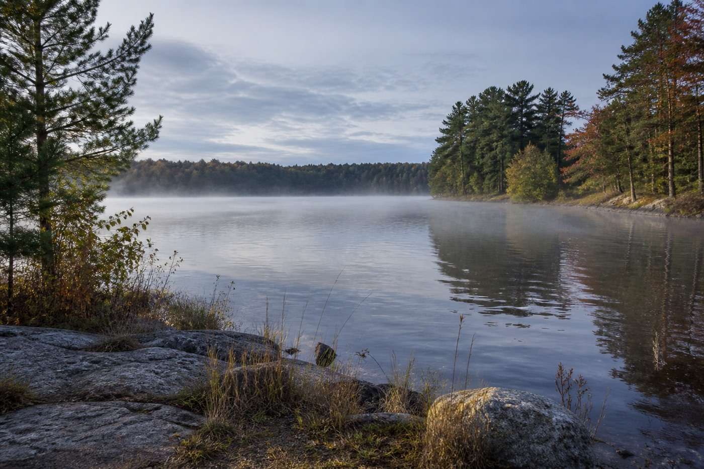 Calm alpine lake representing long-range planning after a business sale